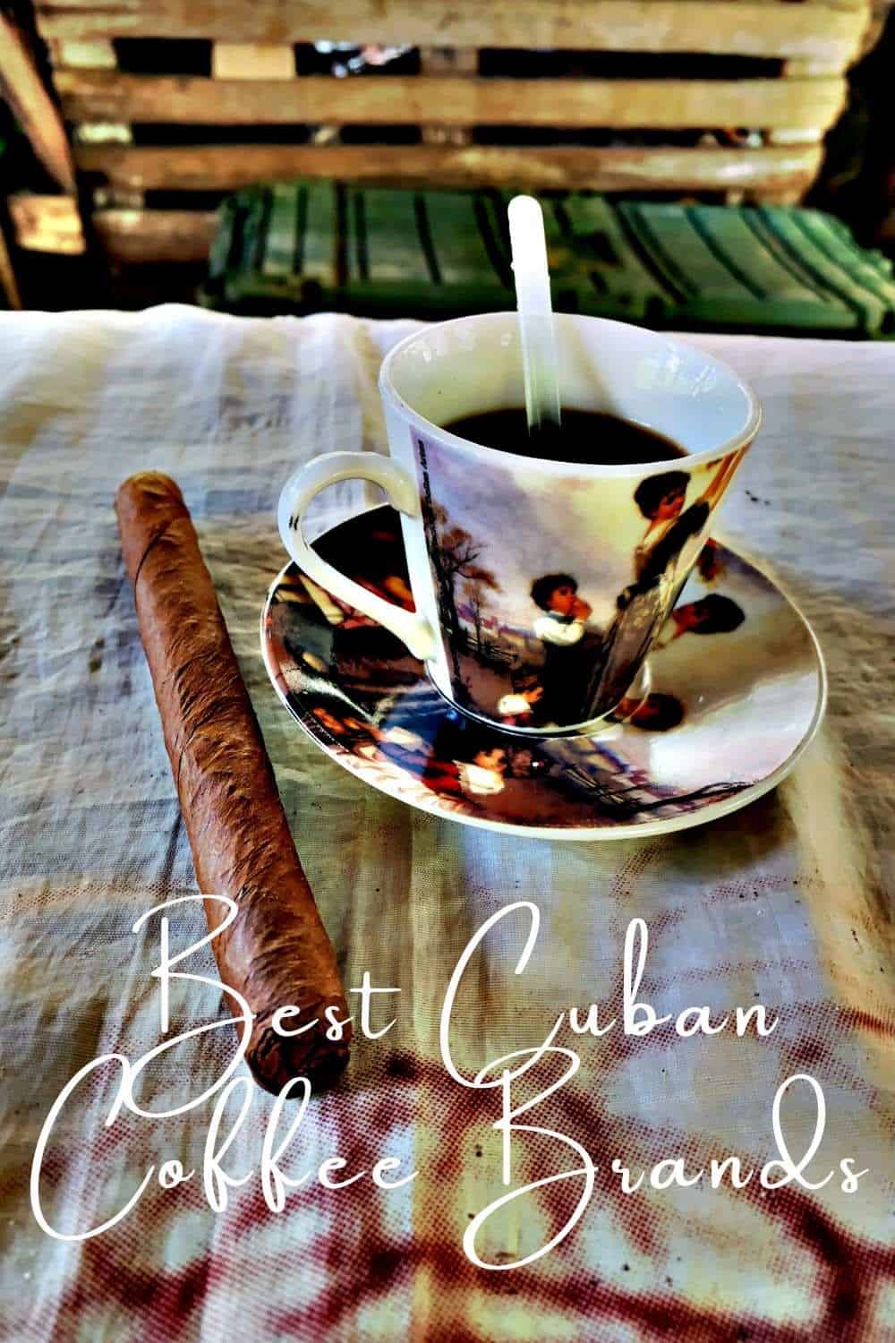 A small cup of black coffee in a decurated cup on a table next to a big fat cuban cigar