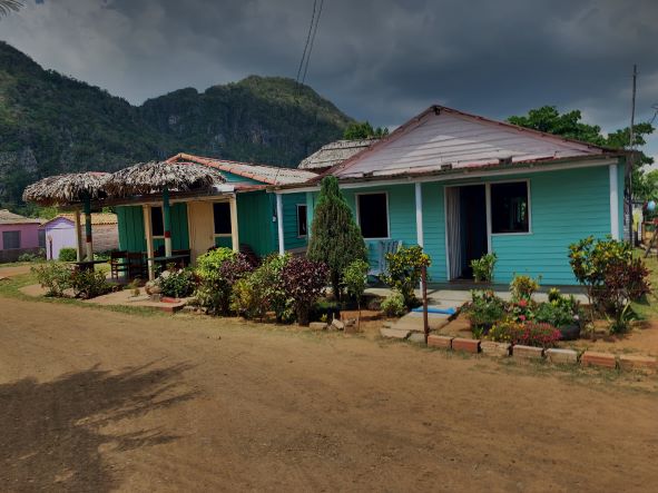 Casa particulares Vinales Valley. These two small wooden houses painted in bright pastel blue with shaded front porhces is the kind of casa you might stay at in Vinales Valley Cuba.