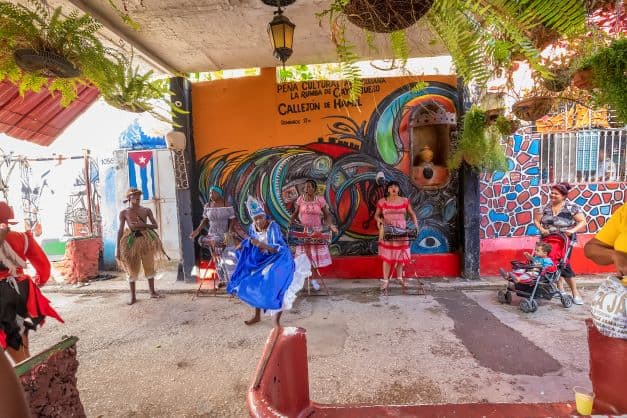 Cuban dance styles; woman dancing in colorful costume in Callejon de Hamel in Havana, Cuba