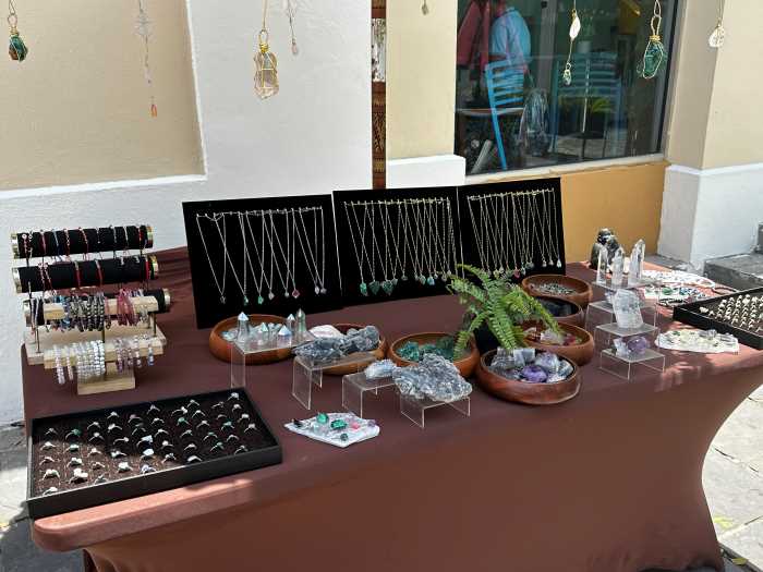 Gemstone market in Old San Juan with lots of colured and shiny gemstones, crystals, rings and bracelets displayed on a table