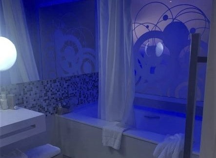An elegant bathroom with a large tub and blue lights in Melia International Varadero, Cuba