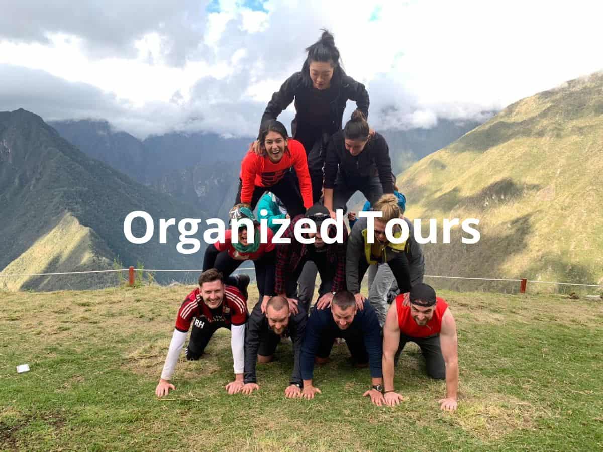 Top rated organized tours: here is the small group tour group that I walked the Inca Trail trek with, doing a pyramid in the middle of the mountains in Peru!