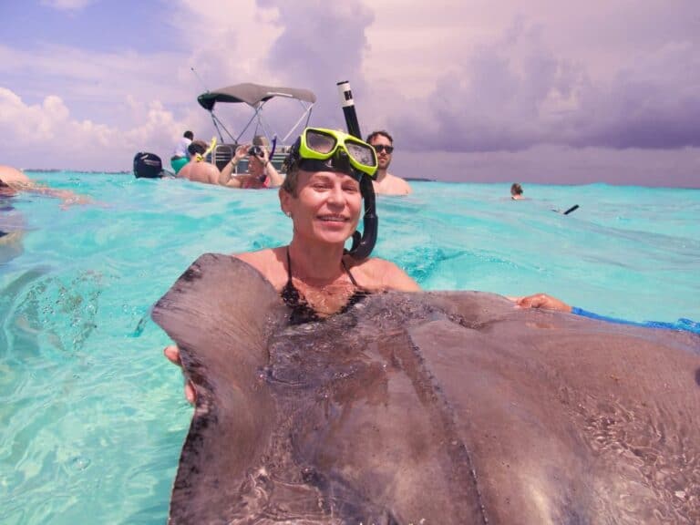 Kissing a stingray! Unique things to do in Grand Cayman traveling solo