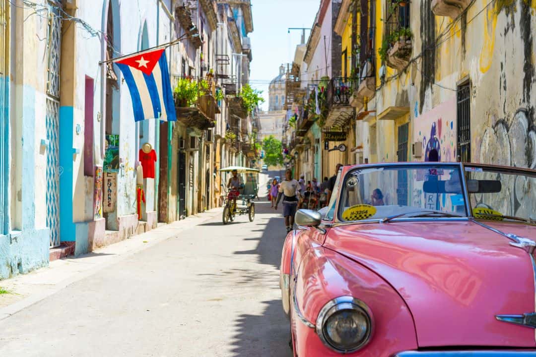 Cuba visa for Indians? Walk these streets between Classic American cars and colonial architecture, with the Cuban flag out the window