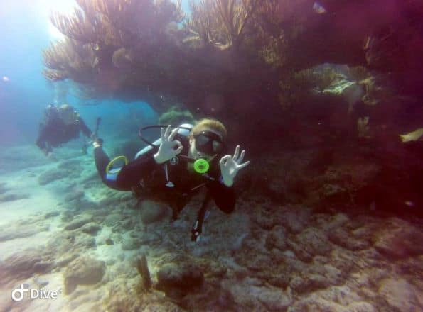 Scuba diving in Cayo Santa Maria, swimming slowly along the white sandy bottom 