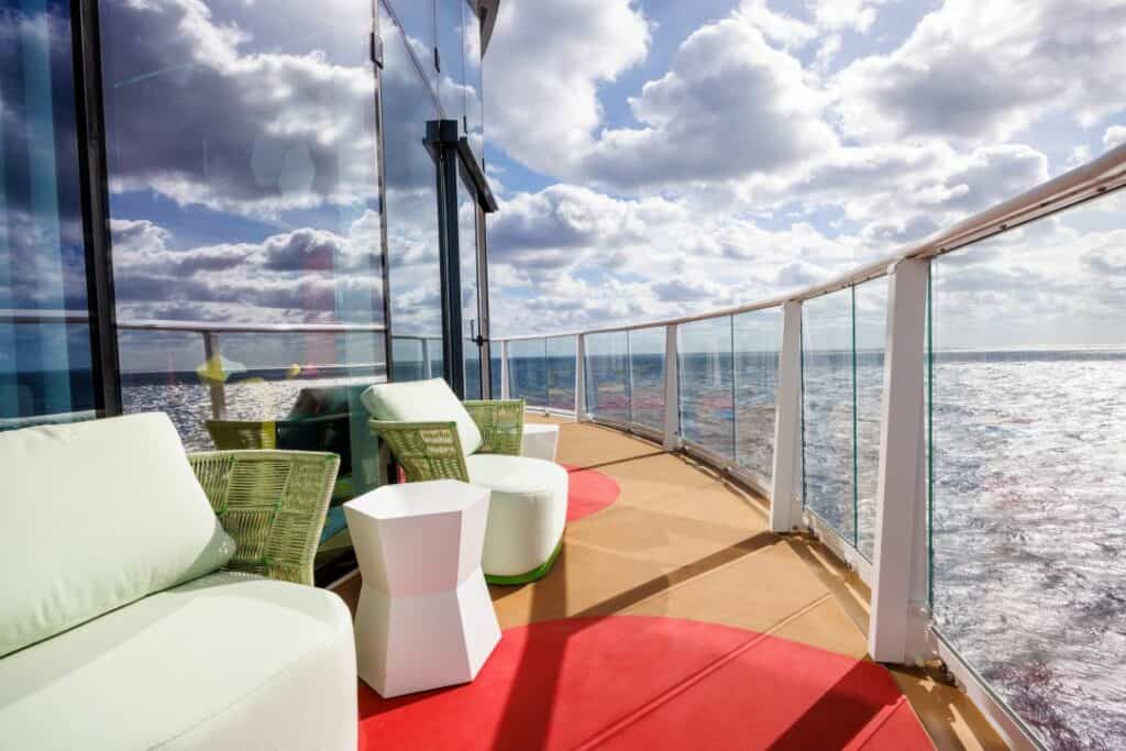 Outdoor seating at Icon of the seas with incredible sea views through the glass fence