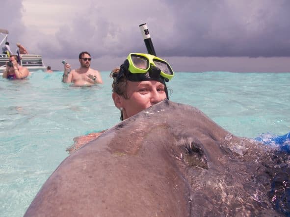 Me kissing a stingray in the crystal clear waters of Stingray City in Grand Cayman