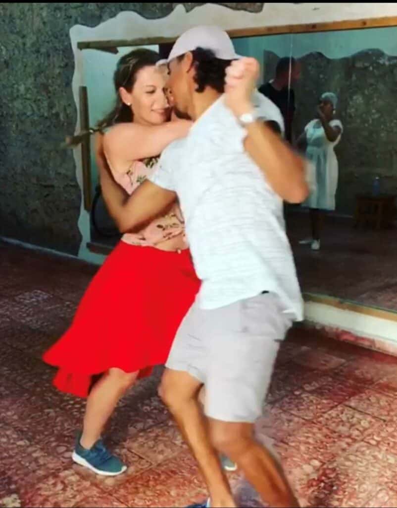 Dance class in Havana, me with a red skirt and pink blowse, looking happy. You will feel super welcome when you drop by Casona del son to sign up for a salsa class Havana Vieja, in the heart of Old Havana! 