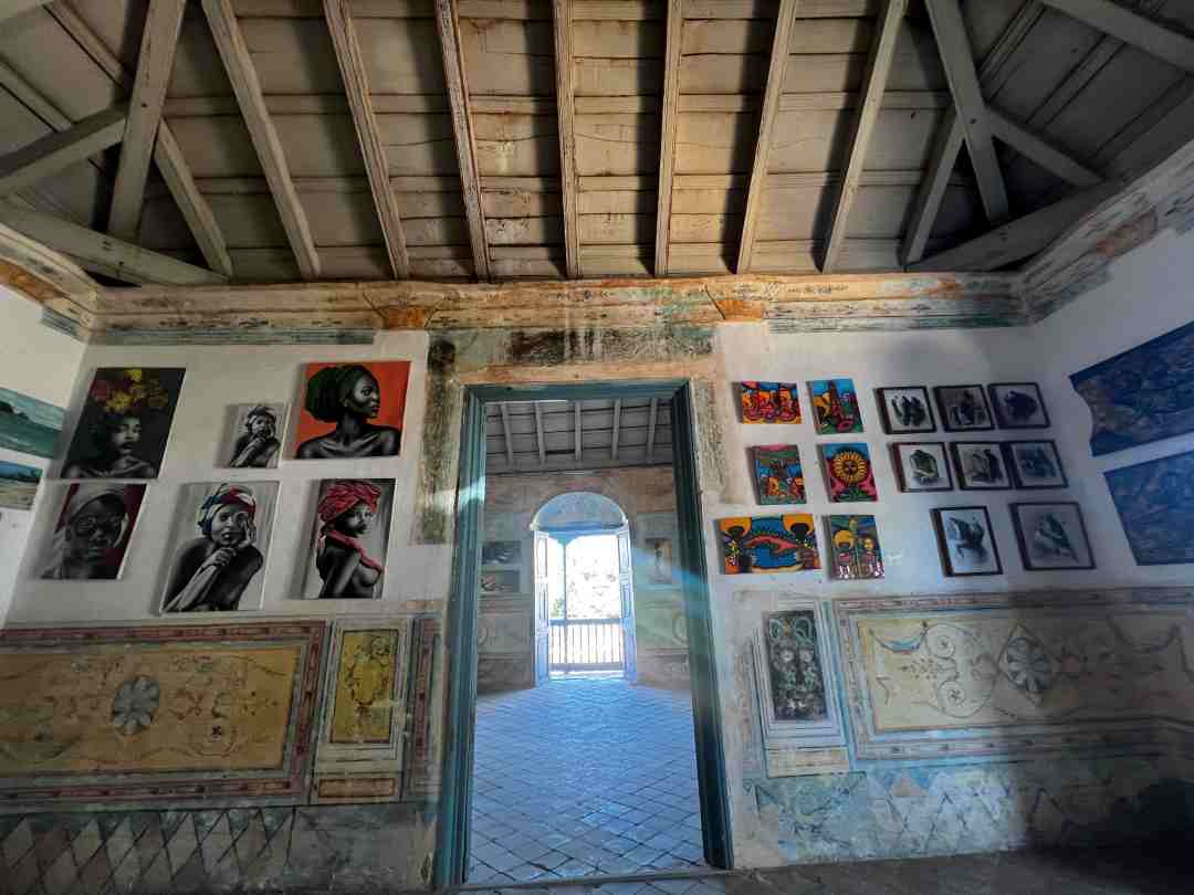 Inside an art gallery in Trinidad, where there are art displayed on the walls, but the entire house with elaborate tall ceilings, paintings on hte walls and decorated floors is also like a piece of art. 