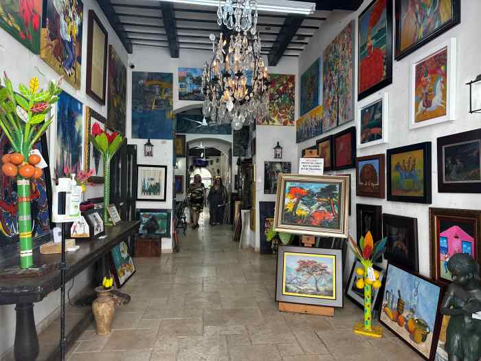 Art shop in Old San Juan in Puerto Rico with a large exhibition of colorful art 