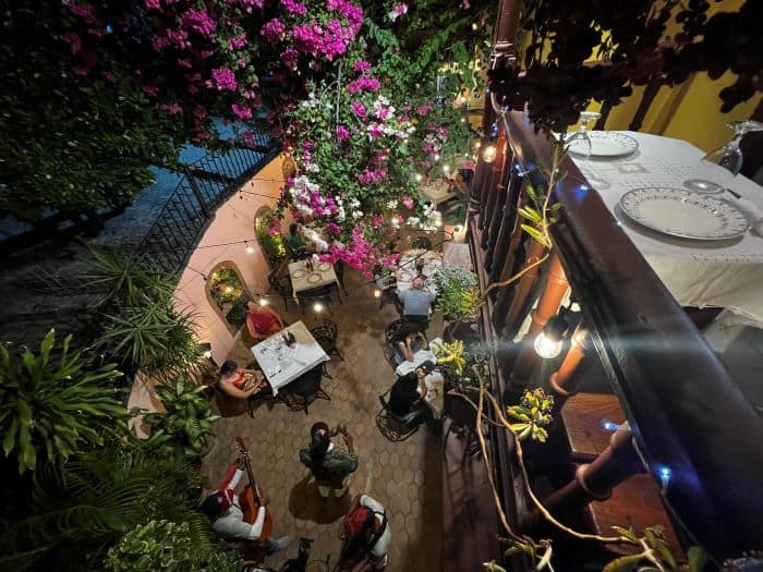 A cozy restaurant with outside seating in Trinidad Cuba, with lots of flowers, live music, and a wonderful atmorphere. 