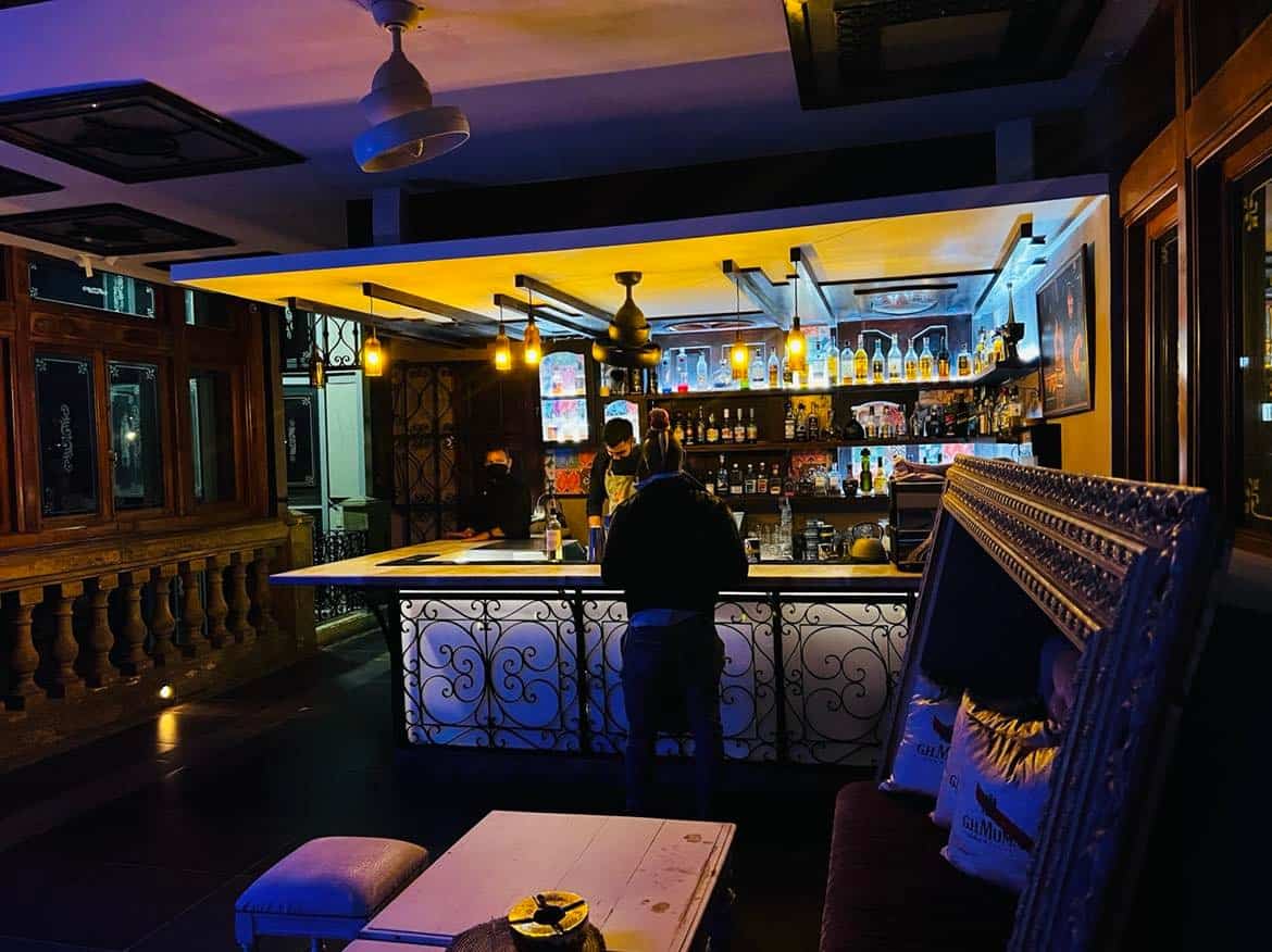 The elegant La Guarida rooftop bar with exquisite furniture and interior, and the bar is beautifully lit. 