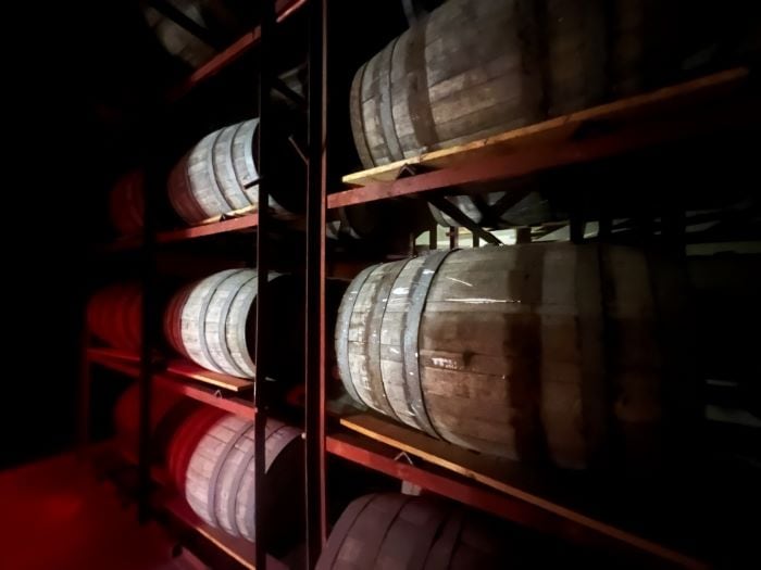 Old wooden rum barrels on shelves inside the Museum of Rum in Puerto Plata, Dominican Republic