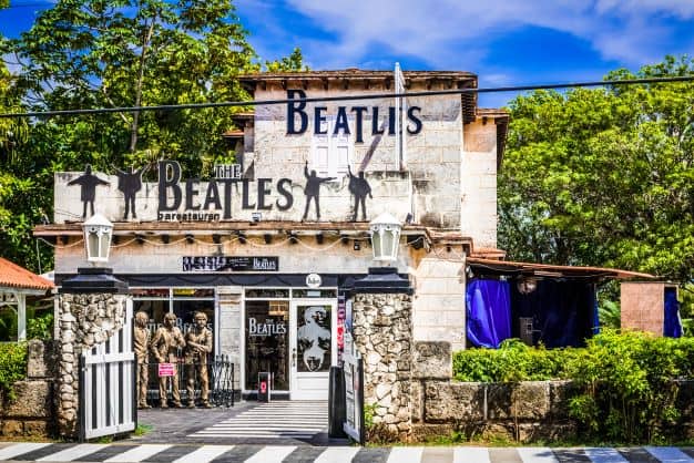 The stone facade of the Beatles Bar in Varadero, where the "guys" are standing outside to welcome you