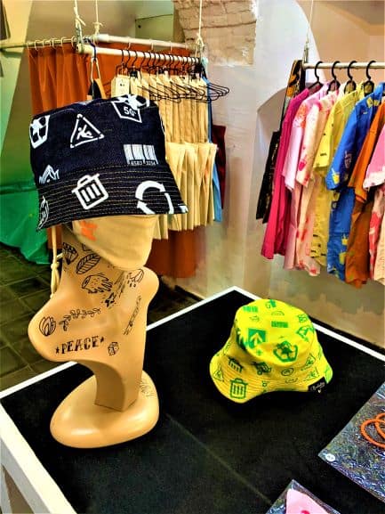 Displayed colorful hats and t-shirts in Clandestina shop in Havana Cuba
