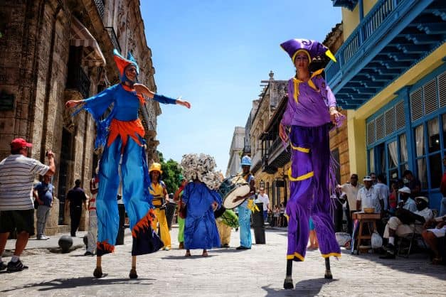 Stylt dancers in colorful clothing in Obispo street Havana