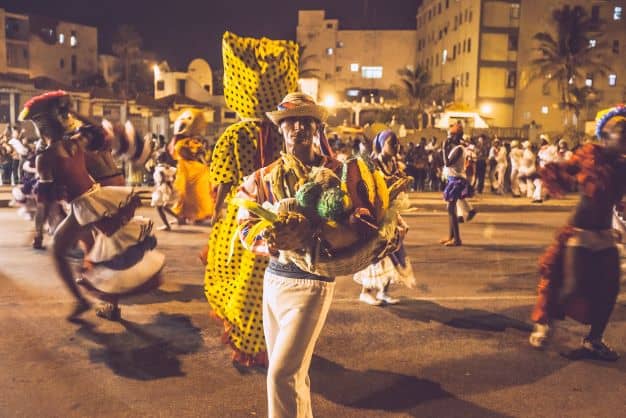 Street dancers at the carnival in Cuba at night, with elaborate costumes. 