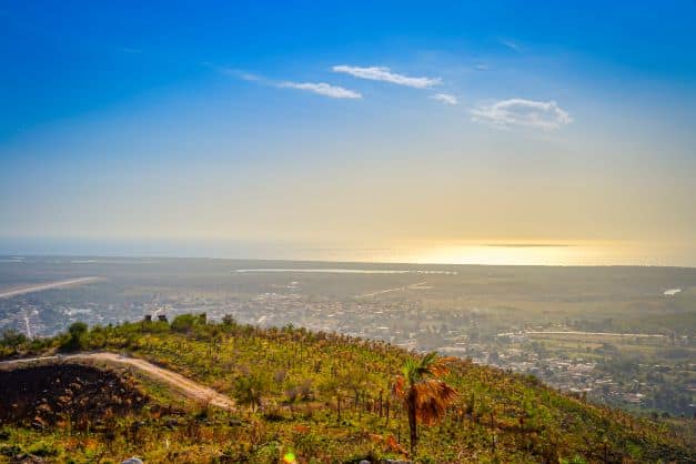 Stunning views from Cerro de Vigia Hill outside Trinidad, with infinite views of the green plains below, the blue sea and sky. 