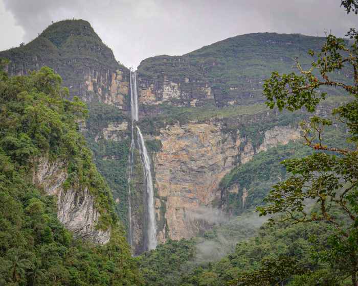 The tall Cocachimba Waterfall in Peru from afar, the thin line if the over 700 meters high waterfall is like a white line on the rocky and green steep mountain side. 