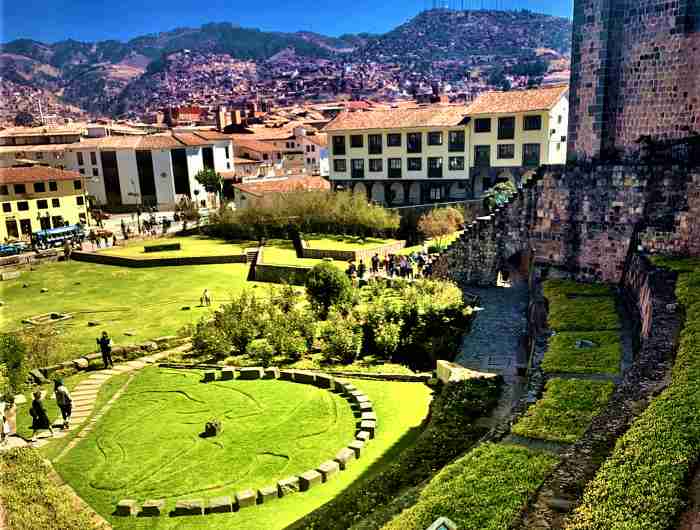 The incredibly green grass in the Convent Park next to the ancient convent in Cusco, Peru on a bright sunny summer day. 