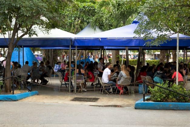 Coppelia Ice Cream Parlor seating area, where lots of people are seated enjoying the famous Coppelia ice cream. 