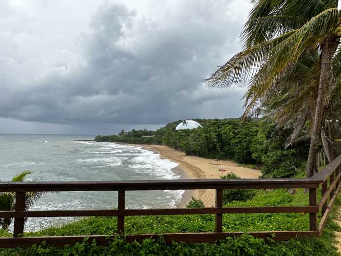 The small secluded Domes Beach beneath the Rincon Lighthouse, sheltered by lush green forest