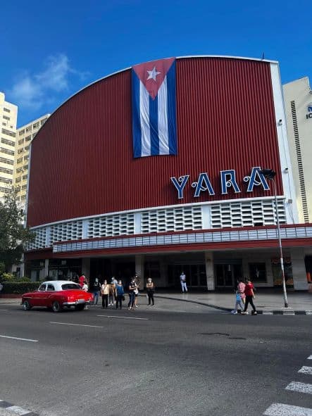 The iconic red facade of the Cine Yara cinema, a historic place in Havana that has been home to many important cultural and music events. 