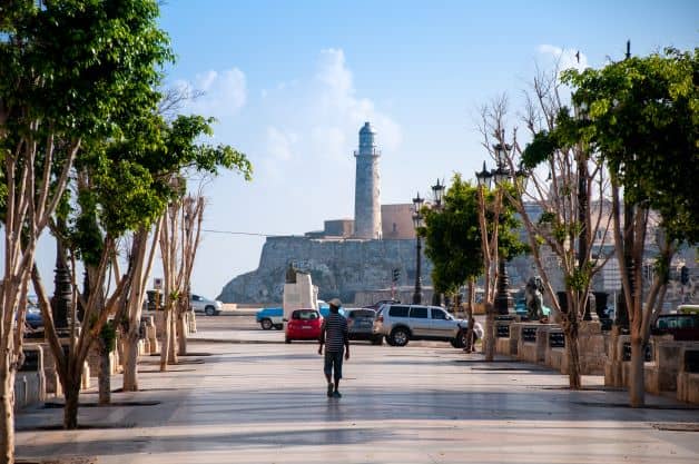 The El Morro Lighthouse across the Havana bay seen from the end of the Prado Avenue on a bright sunny day with blue skies