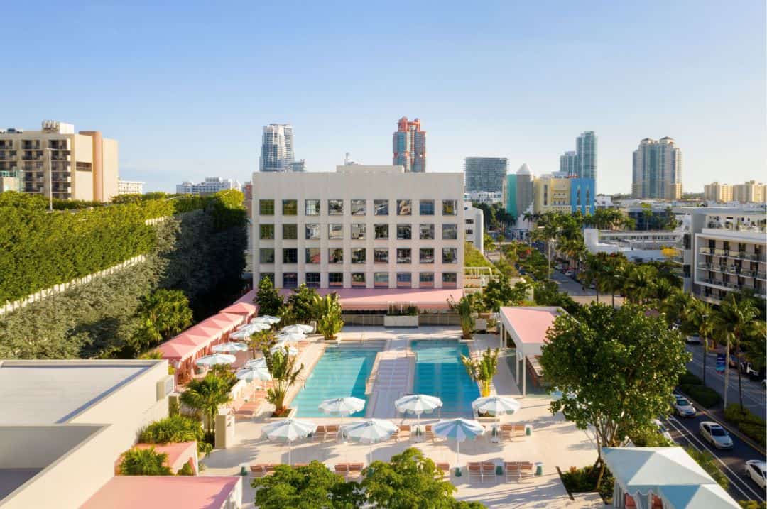 Overview photo of the Goodtime Hotel in South Beach Miami, with the stunning pool area with sun loungers and parasols on a bright summer day. 