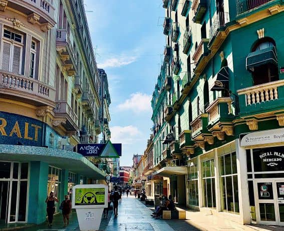 San Rafael Avenue in Havana, a pedestrian street with shops and casual cafes between elegant colonial architecture houses in bright pastel colors