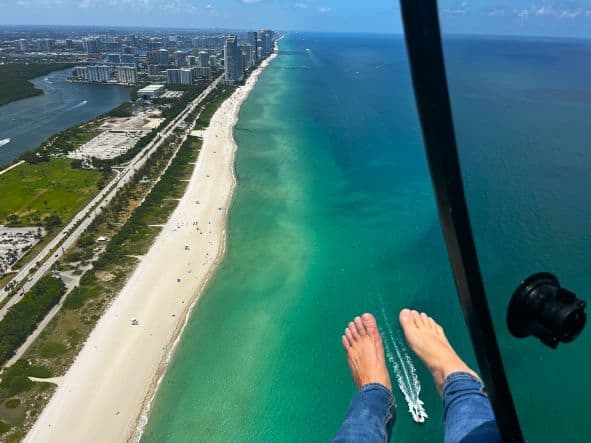 Feet out on my helicopter tour from Fort Lauderdale flying over the white sandy Miami Beach