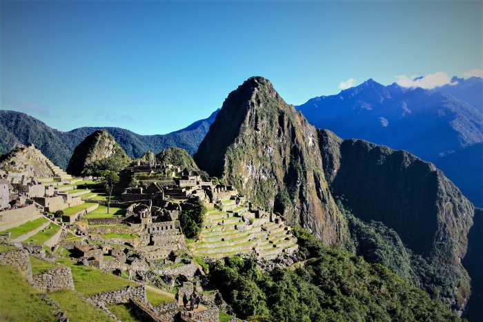 Visit the magnificent ruins of Machu Picchu in the Peruvian mountains to get it all into perspective, both time, space, and your tiny space in it! Here is Machu Picchu on a bright sunny summer day, with clear blue skies and infinite mountain ranges around it. 
