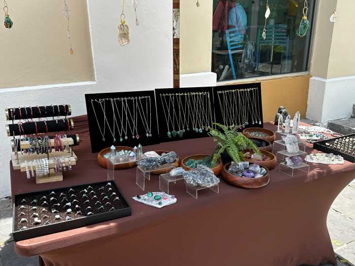 Stone and crystal booth on a market in San Juan, with colorful crystals in raw form, or as necklaces and rings