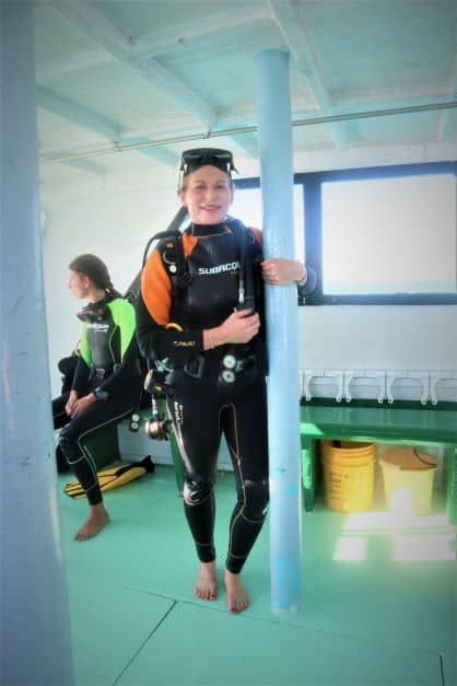 Me smiling on a boat heading out to go scuba diving in Varadero, in wet suit and ready to go with all diving kit. 