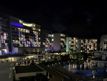 The Melia international pool and hotel area at night, with lights everywhere