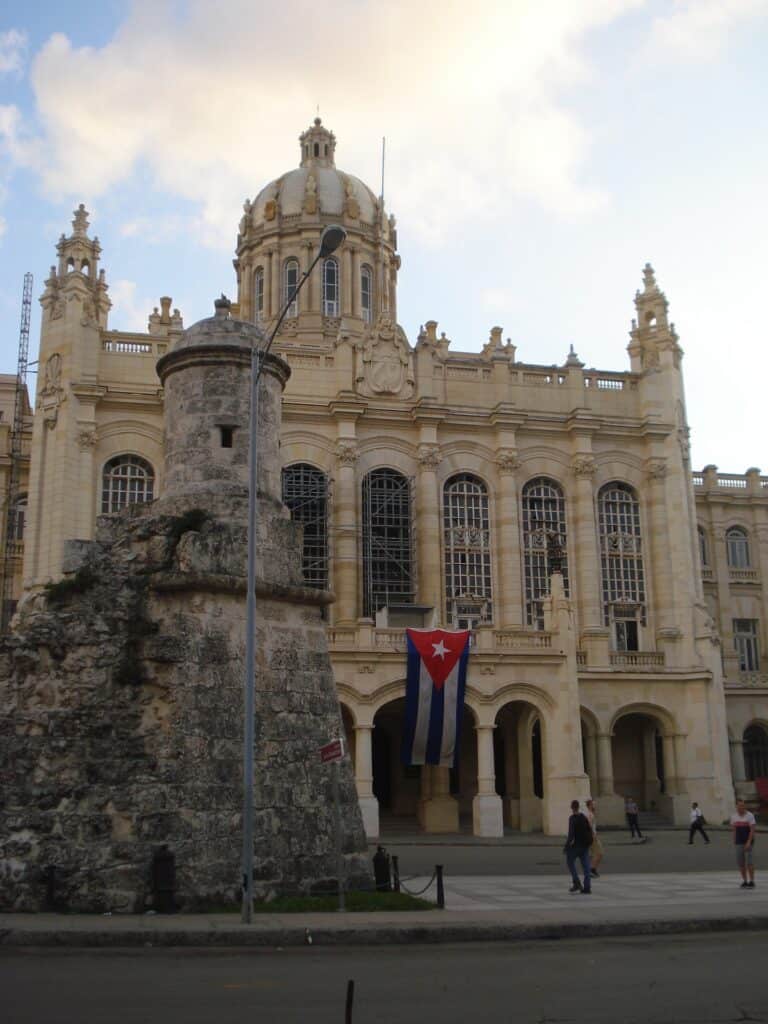 Museum of the Revolution in Havana, an impressive building with lots of artsy details, beautiful windows, towers, and the Cuban flag outside. 