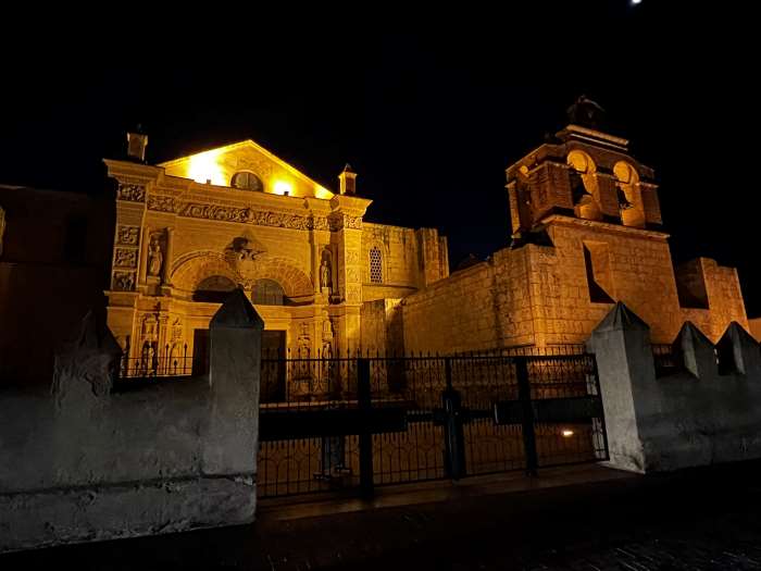 Santo Domingo Cathedral beautifully lif at night with warm lights decorating the stone facades filled with elaborate decorations