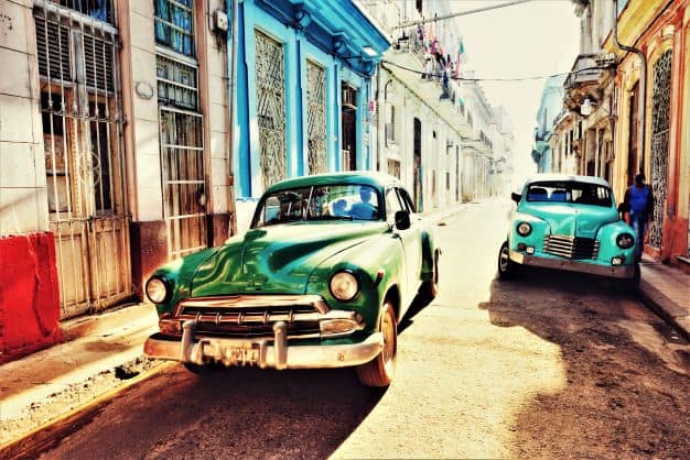 Colorful classic American cars in the narrow streets of Old Havana in Cuba