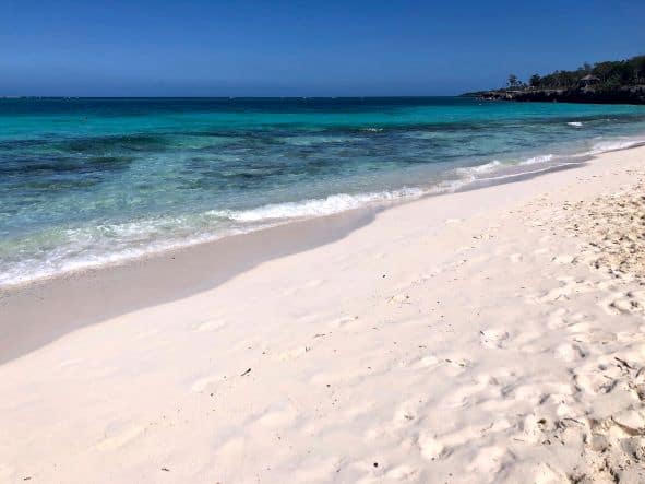 The withe sands of Playa Esmeralda in Holguin along the northern Cuban shores, on a bright sunny summer day with soft waves hitting the beach. 