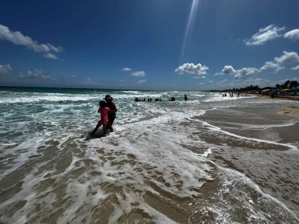 The sand and surf at playas del este on a bright sunny summer day in Havana Cuba