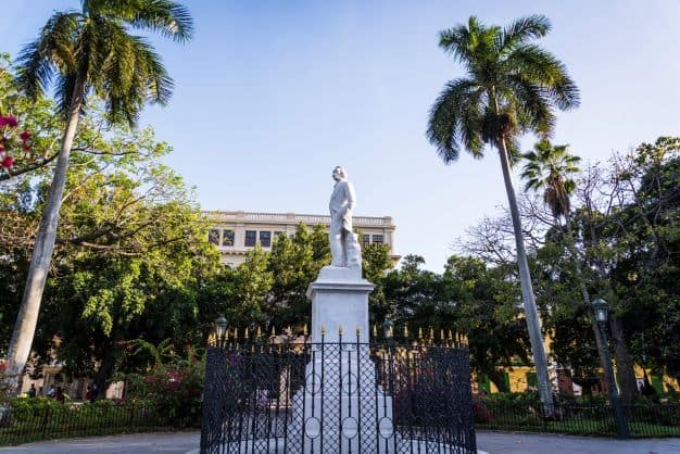 The white statue of Jose Marti on Plaza de Armas in Old Havana Cuba on a bright sunny day