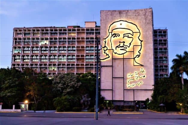 Plaza de la Revolucion at night in Havana, with the art illustration of Che Guevara on a large building wall. 