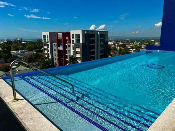 My Airbnb pool in Kingston on the 7th floor of an apartment building. It is an infinity pool where you can swim and have spectacular views of the city from the seemingly blue water. 
