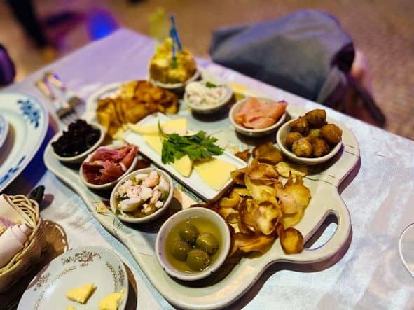 Close up photo of an aperitizer tapas plate at San Cristobal Havan, wiht olives, cheese, and a variety of tasty small dishes. 