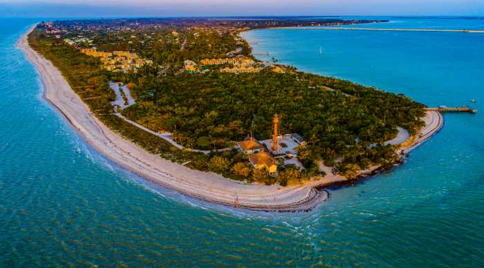 Aerial photo of Sanibel Island outside Fort Mayers, with white sandy beaches lining the shores outside green vegetation