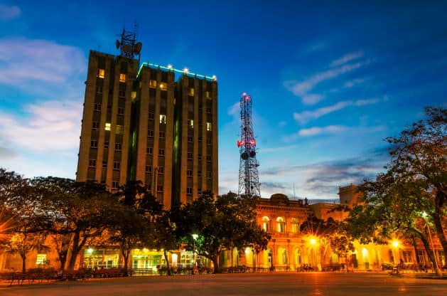 Night photo from Parque Vidal, with warm lights coming from all the buildings around the square under a dark blue evening sky