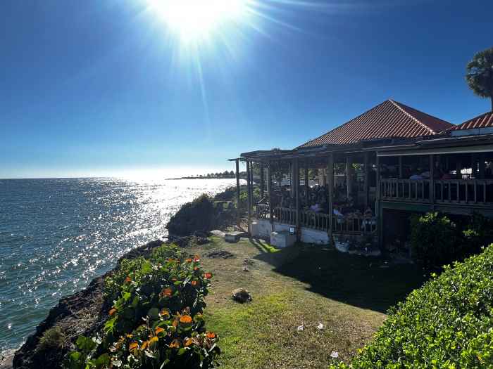 Seaside restaurant in Santo Domingo sitting on a green grass hill on a sunny summer day with impeccable sea views