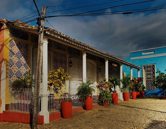 Colorful houses in Trinidad decorated with flowers and bushes on the outside