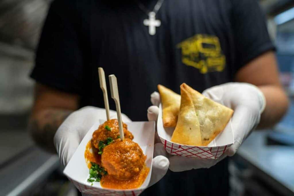 Tasty fried street food in the hands of a chef
