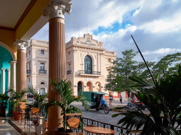 The Teatro de la Caridad inside a light pinkish brick built classic elegant colonial building beside Parque Vidal. 